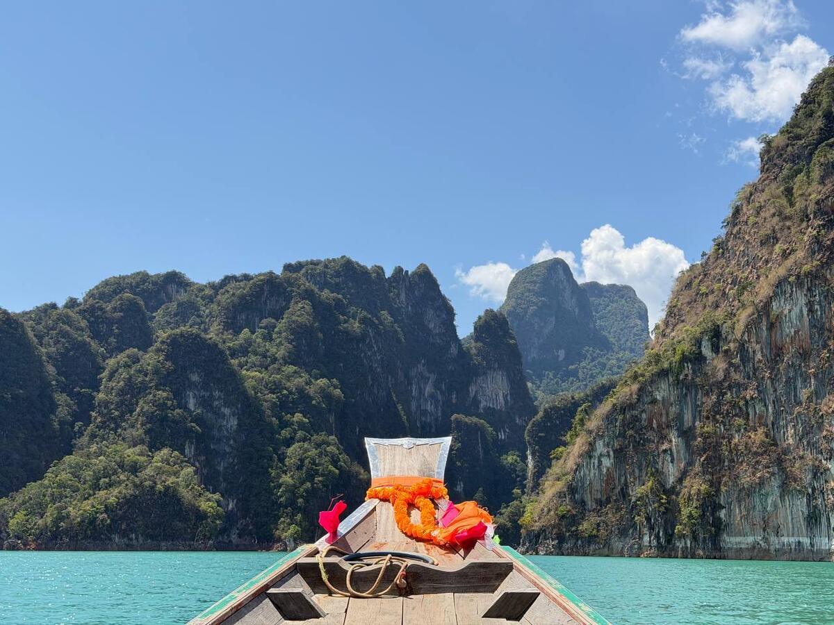 Guests on the bow of a longtail boat at Cheow Lan lake